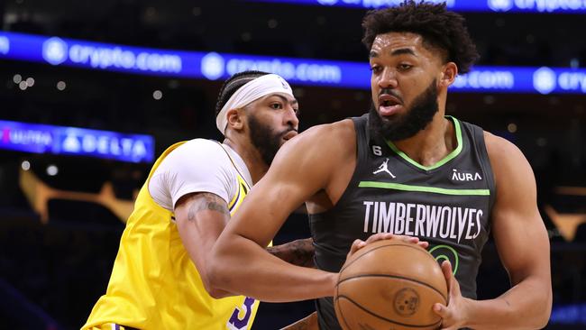 Karl-Anthony Towns of the Minnesota Timberwolves spins from Anthony Davis of the Los Angeles Lakers. Picture: Harry How/Getty Images