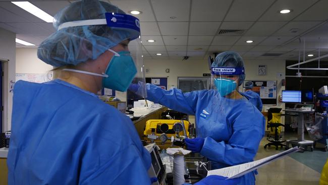 Frontline ICU staff prepare to treat a patient. Picture: Kate Geraghty