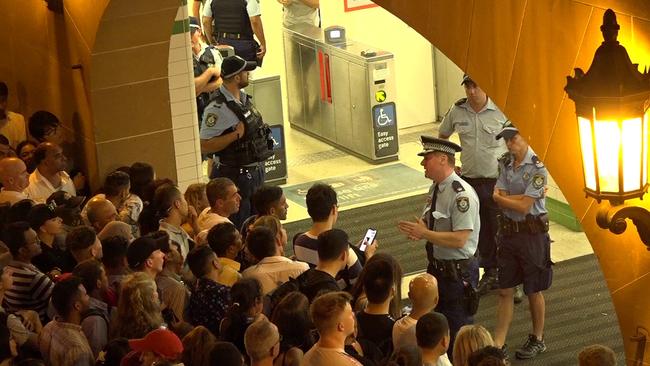 Police speak to the large crowd outside Central Station on Monday night. Picture: TNV