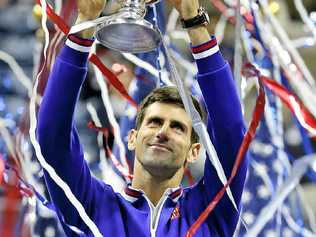 NEW YORK STATE OF MIND: Novak Djokovic holds up the championship trophy after defeating Roger Federer in the US Open final. Picture: Julio Cortezaap