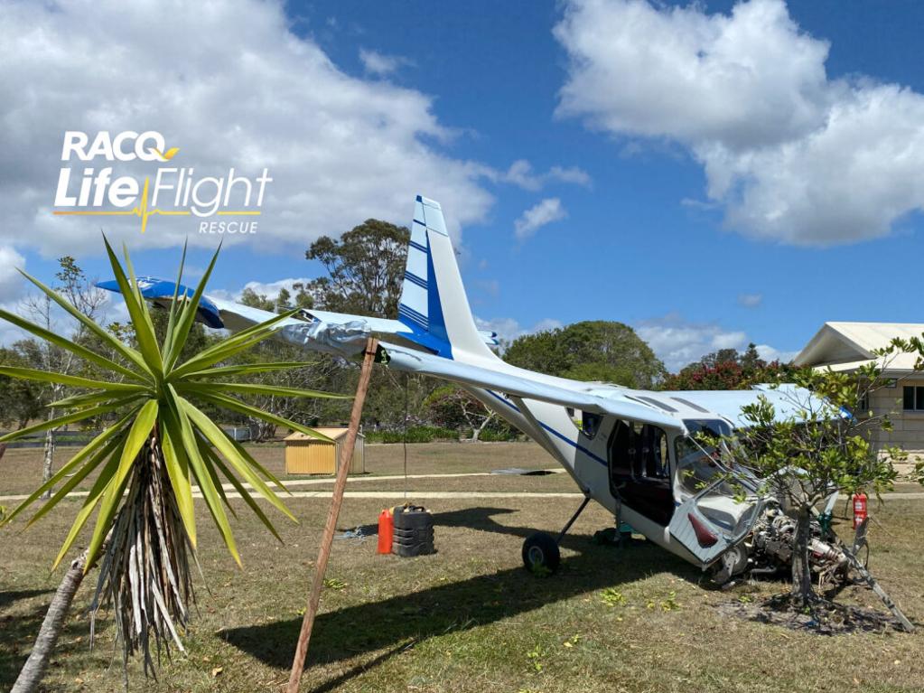 The aircraft clipped palm tree and somersaulted across a private property. Picture: RACQ LifeFlight