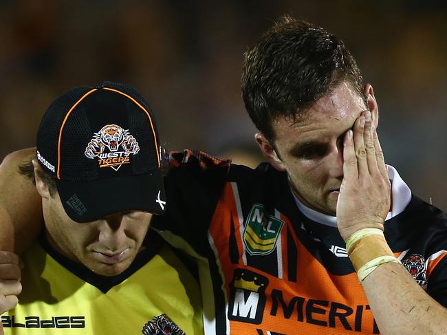 SYDNEY, AUSTRALIA - APRIL 27:  Tim Moltzen of the Tigers is helped from the field with an injury during the round seven NRL match between the Wests Tigers and the Brisbane Broncos at Campbelltown Sports Stadium on April 27, 2013 in Sydney, Australia.  (Photo by Mark Kolbe/Getty Images)