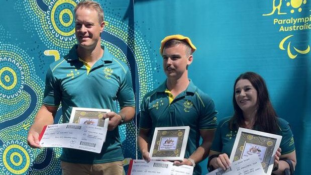 Paracanoe representatives (from left) Curtis McGrath, Dylan Littlehales and Susan Seipel receive their boarding passes and berets after being the first athletes named to Australia’s Paralympic team.