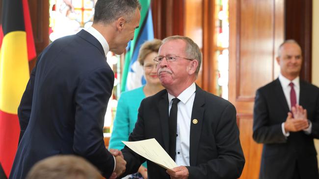 Local Government, Regional Roads and Veterans Affairs Minister Geoff Brock is congratulated by Premier Peter Malinauskas after his investiture. Picture: NCA NewsWire/Dean Martin