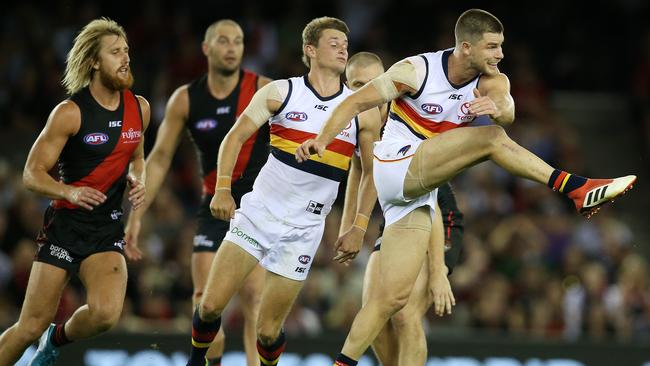 Adelaide's Bryce Gibbs kicks clear of Essendon opponents last season. Picture: Michael Klein