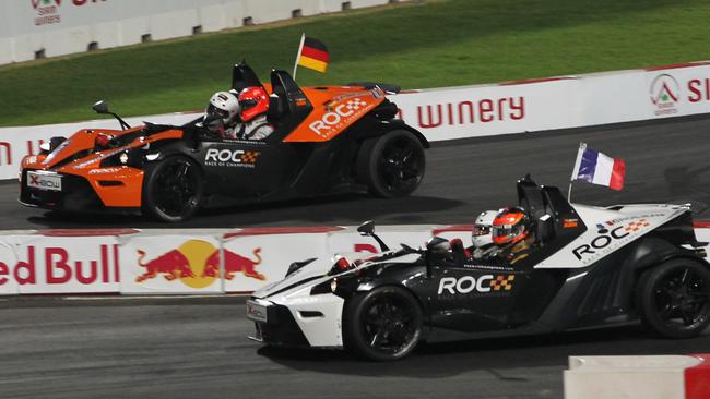 Romain Grosjean of France, foreground, competes to win over Michael Schumacher of Germany, driving KTM X-Bow cars in the 2012 Race Of Champions. AP Photo/Apichart Weerawong