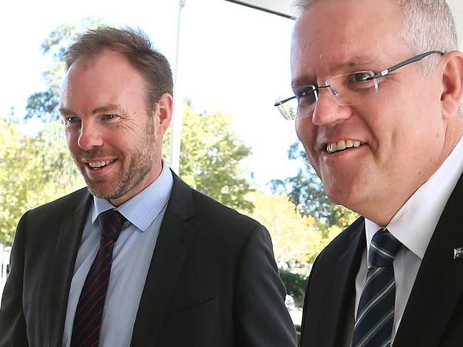 Deputy Secretary of Fiscal Group at Treasury Michael Brennan meeting Treasurer Scott Morrison as he arrives at the Treasury Building in Canberra. Picture Kym Smith