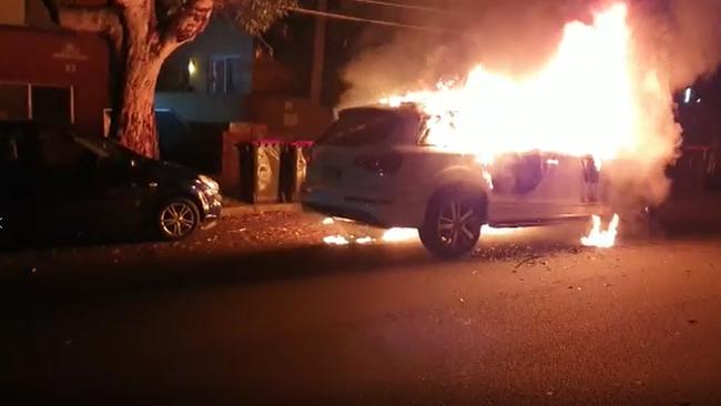 One of the getaway cars bursts into flames. Picture: TNV