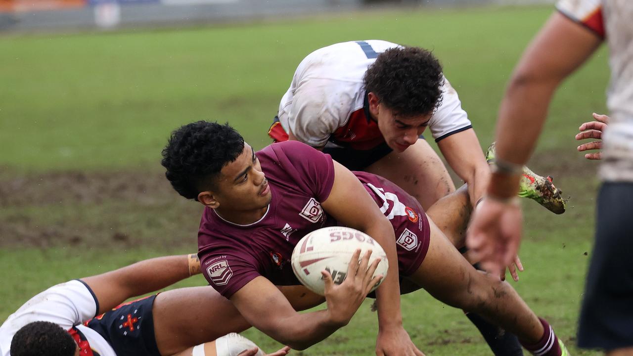 QLD player Karl Oloapu looks to pop a pass. Picture: Liam Kidston