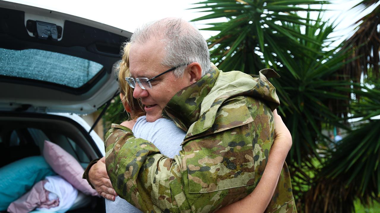 Prime Minister Scott Morrison is seen hugging a resident in a flood affected area in Townsville yesterday. Picture: AAP/Dave Acree