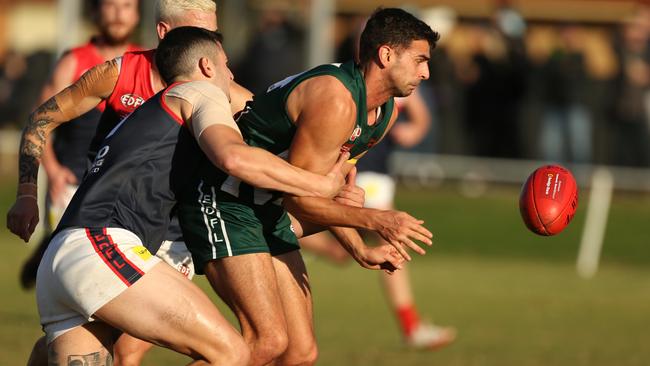 EDFL: Ivan Pavlovic gets a handball away for Airport West. Picture: Stuart Milligan