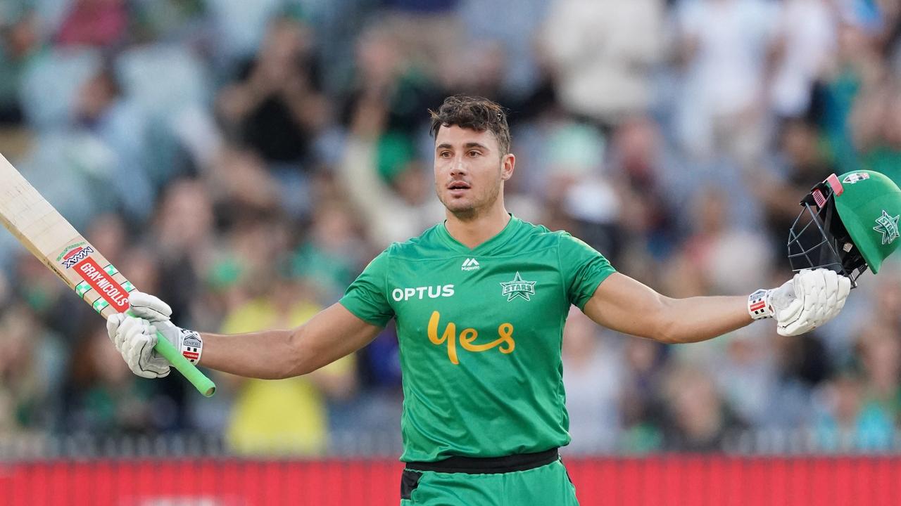 Marcus Stoinis raises his bat after reaching a century against Sydney Sixers.