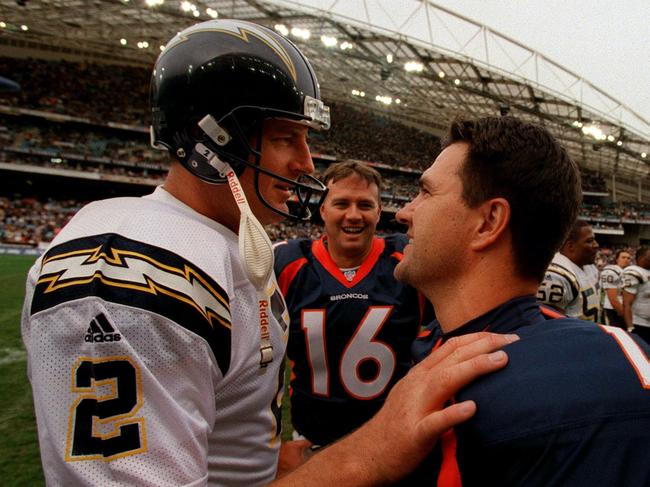 Chargers punter Darren Bennett congratulates Broncos counterpart Jason Elam after their pre-season clash at Stadium Australia in 1999.