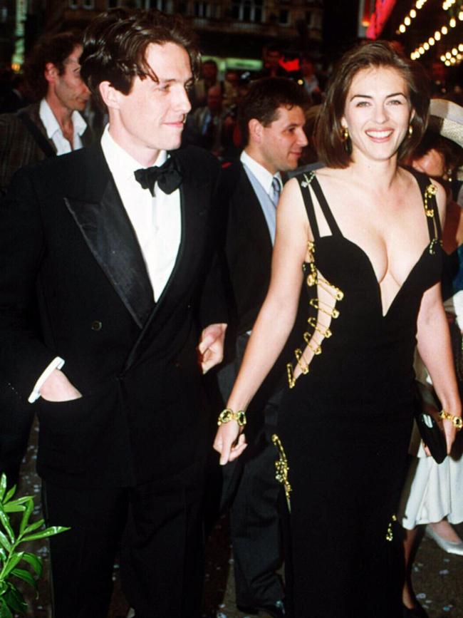 Grant looking loved-up with Elizabeth Hurley in 1994 before his shock arrest. Picture: UPPA