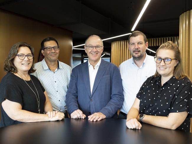 PwC Australia team members Jenny Scott, Michael McGregor, Tom Seymour, Sean O’Meara and Lauren McNamara standing in the new Darwin office. Picture: Floss Adams