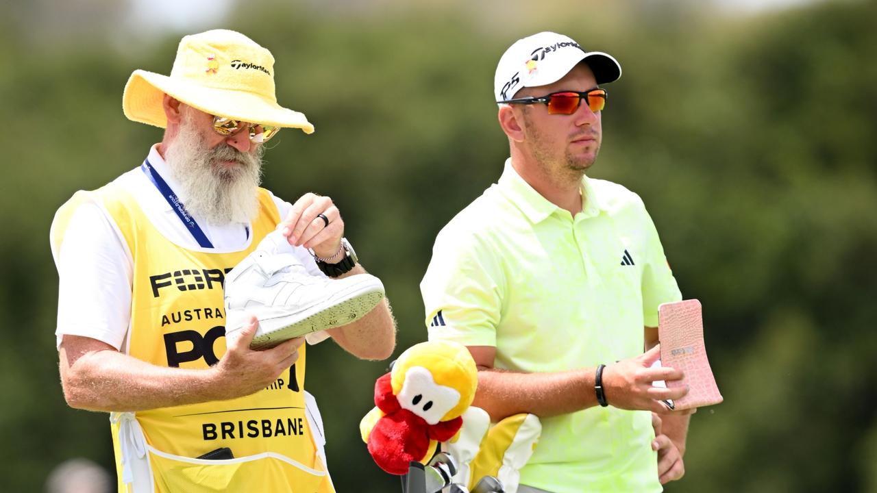 Lucas Herbert and his caddie Nick Pugh decked out in yellow on day two of the Australian PGA Championship a (Photo by Bradley Kanaris/Getty Images)