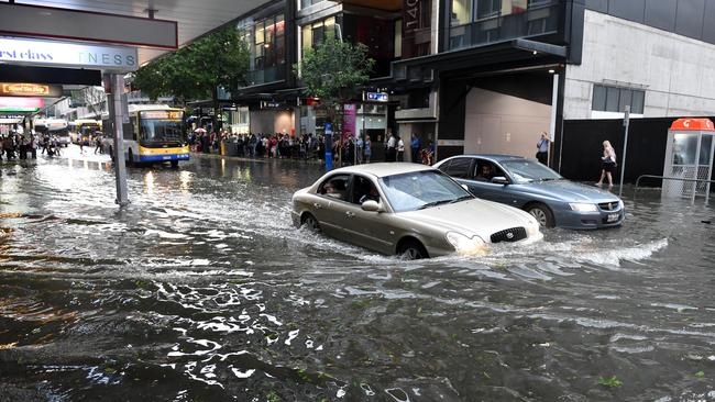 A car drives through flood water in Brisbane's CBD after a severe thunderstorm swept through the city, Thursday, Nov. 27, 2014. (AAP Image/Dan Peled)