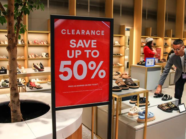 SYDNEY, AUSTRALIA - DECEMBER 24: A sales assistant arranges shoes at the David Jones flagship store on Elizabeth Street on December 24, 2024 in Sydney, Australia. The Australian economy is experiencing subdued growth, with GDP increasing by only 0.2% in the second quarter of 2024, largely due to declining consumer spending and high interest rates. Household consumption has dropped, reflecting ongoing cost-of-living pressures, as consumers prioritize necessities over discretionary spending. (Photo by Roni Bintang/Getty Images)