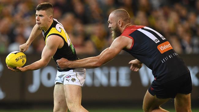 Jack Higgins is tackled by Max Gawn.