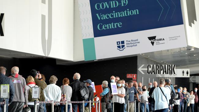 People queue at the Melbourne Convention and Exhibition Centre for their Covid vaccination. Picture: NCA NewsWire / Andrew Henshaw