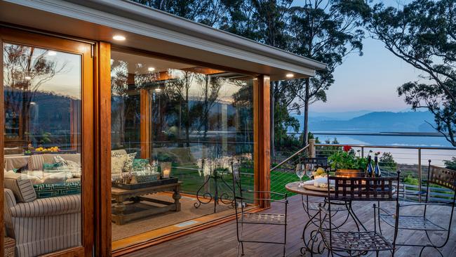 The outlook from the Huon River Hideaway looking along the verandah to the river and Hartz Mountains. Picture: Jon Jarvela Photographs