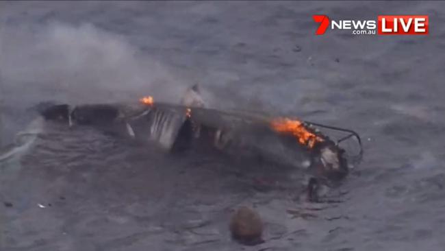 A boat destroyed by fire seen in waters off the Gold Coast. Picture: 7 News.