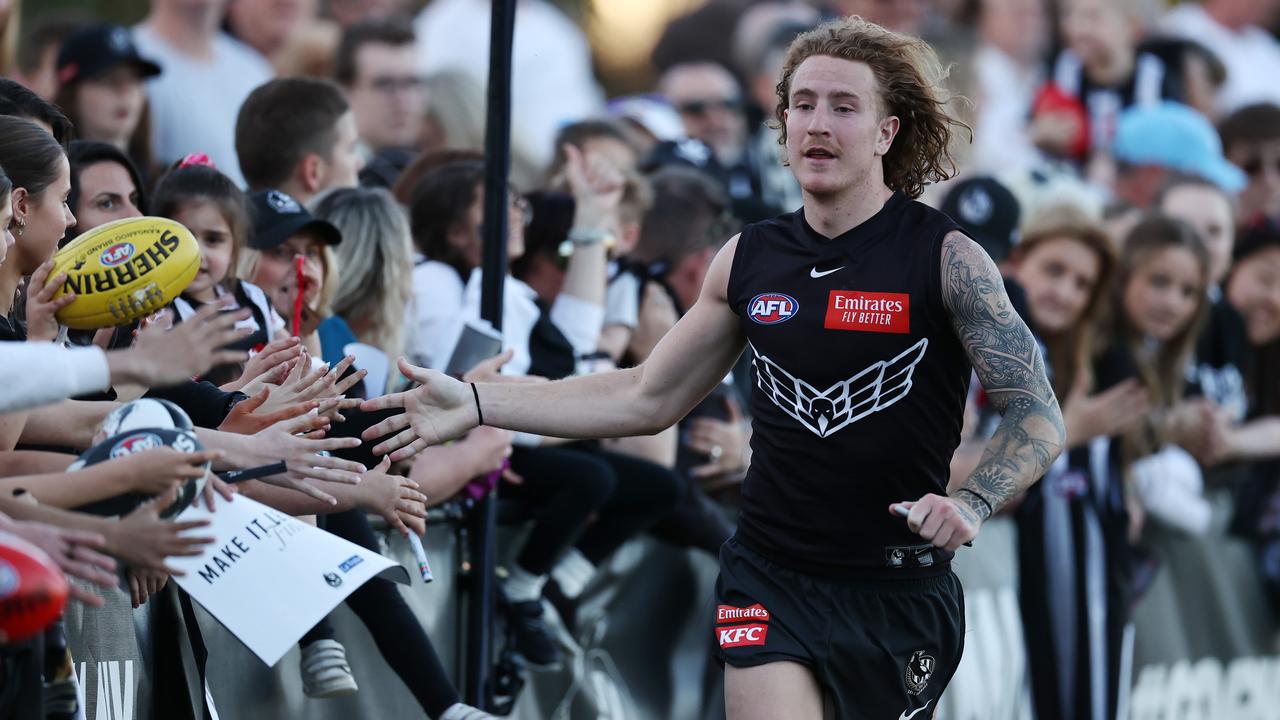 MELBOURNE, AUSTRALIA - September 15, 2023. AFL. Beau McCreery of the Magpies high 5s the crowd after Collingwood training session at Olympic Park. Photo by Michael Klein.