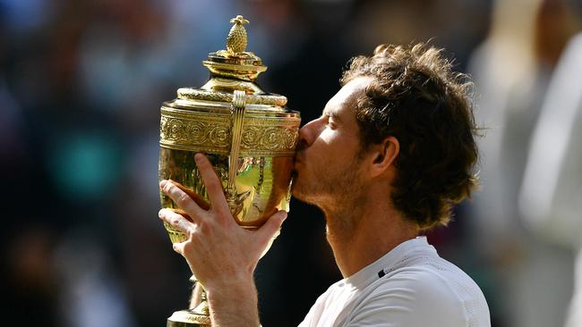 Britain's Andy Murray kisses the winner's trophy after his men's singles final victory over Canada's Milos Raonic on the last day of the 2016 Wimbledon Championships. Picture: Leon Neal/AFP Photo