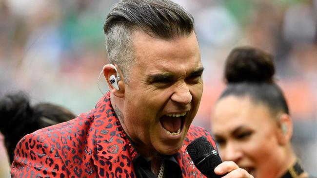 Robbie Williams belts out a tune at the opening ceremony.