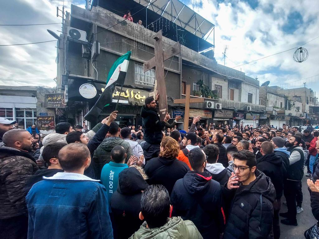 Christian Syrians carried crosses as they rallied in the Duweilaah area of Damascus. Picture: AFP