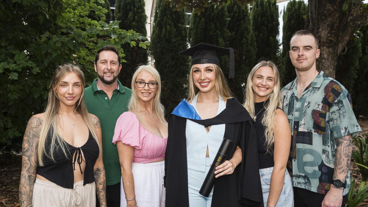 Bachelor of Nursing graduate Madison Whitehouse celebrates with (from left) Brittany Whitehouse, Brad Rissman, Cassii Young, Tayla Whitehouse and Byron Guthrie at a UniSQ graduation ceremony at Empire Theatres, Tuesday, February 13, 2024. Picture: Kevin Farmer