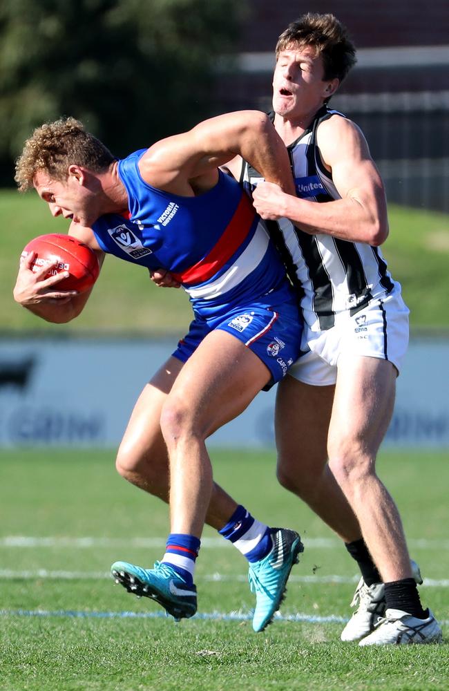 Callan Wellings tackles Bulldog Mitch Wallis at Whitten Oval in May.