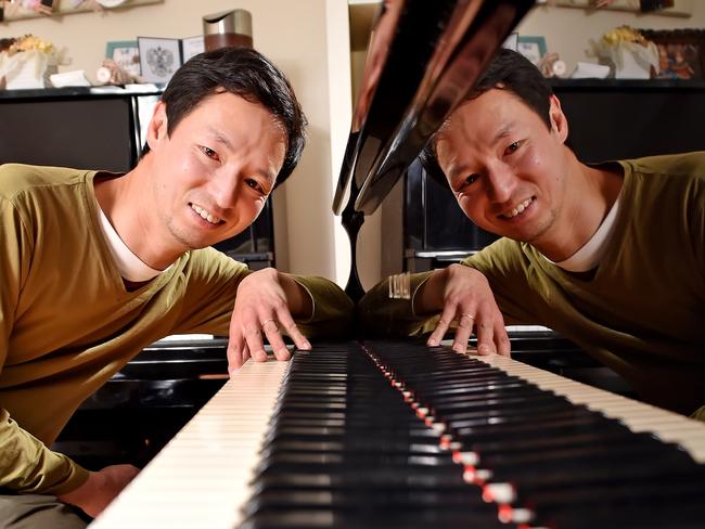 Pianist DJ Ha poses during a photo shoot in his home at St Ives on Monday September 10th. Concert pianist DJ Ha had a stroke 10 years ago which paralysed the right side of his body, and he now is learning to play the piano one-handed. (AAP IMAGE / Troy Snook)