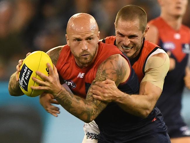 Nathan Jones of the Demons (left) and David Zaharakis of the Bombers contest during the Round 3 AFL match between the Melbourne Demons and the Essendon Bombers at the MCG in Melbourne, Friday, April 5, 2019. (AAP Image/Julian Smith) NO ARCHIVING, EDITORIAL USE ONLY