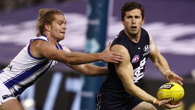 Marc Murphy clears the ball against Jed Anderson in their Round 19 clash at Marvel Stadium. Picture: Michael Klein