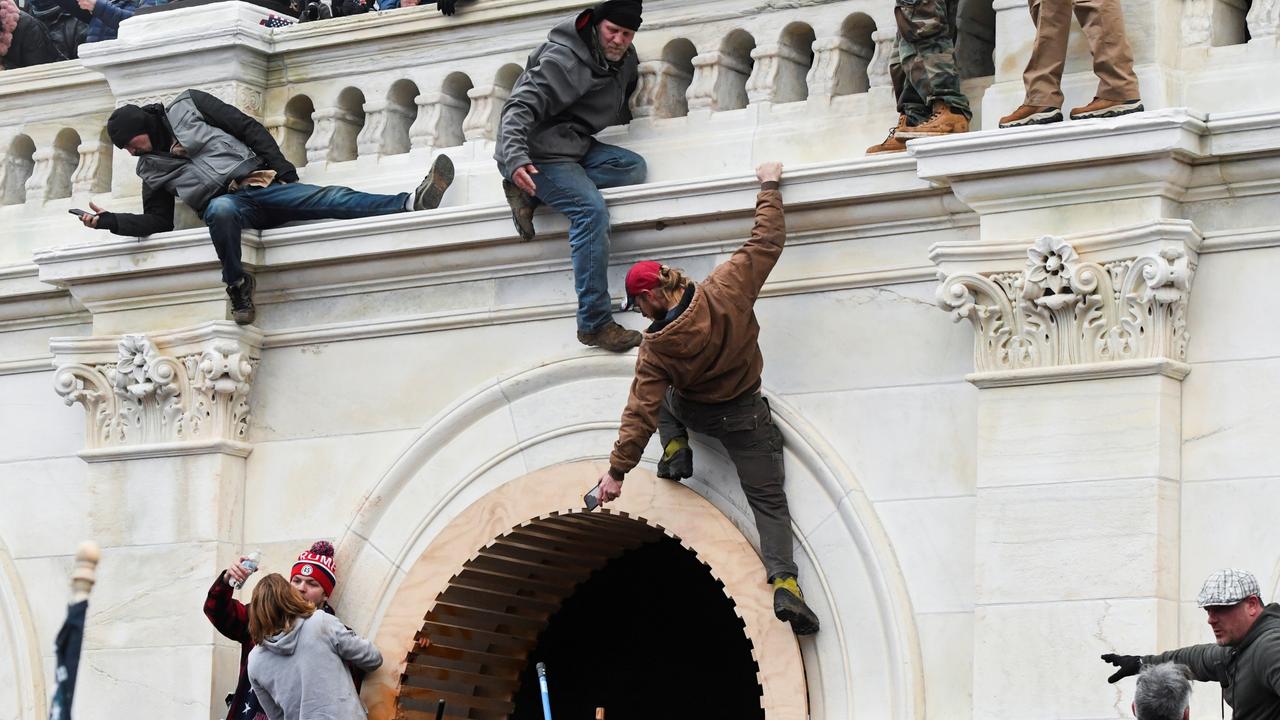 Trump supporters climb walls at the US Capitol building during a protest against the certification of the presidential election results. Picture: Stephanie Keith/Reuters