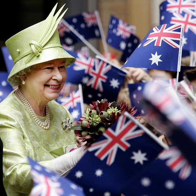 Queen Elizabeth ll receives flowers from waiting schoolchildren waving Australian flags after the Commonwealth Day Service in Sydney, Australia, 13/03/06. Picture: Supplied
