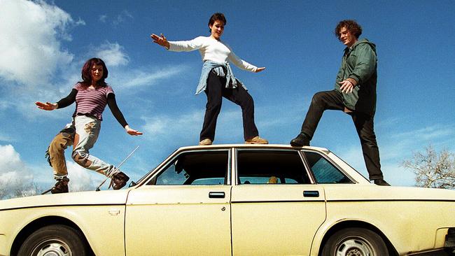 Film makers Heather Croall, Allison Elder &amp; Tom Smith standing on Volvo car, inspiration for their five minute film "Herd of Cows" short listed for Pegasus film awards in 1997. Picture: Supplied