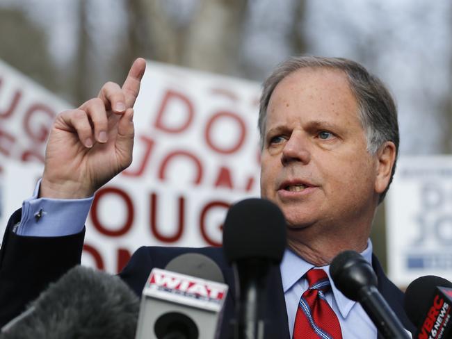 Democratic candidate Doug Jones speaks to reporters after casting his ballot. Picture: AP Photo/John Bazemore