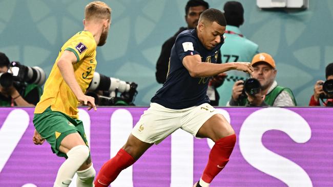 France's forward #10 Kylian Mbappe (R) runs runs with the ball next to Australia's midfielder #03 Nathaniel Atkinson during the Qatar 2022 World Cup Group D football match between France and Australia at the Al-Janoub Stadium in Al-Wakrah, south of Doha on November 22, 2022. (Photo by Jewel SAMAD / AFP)