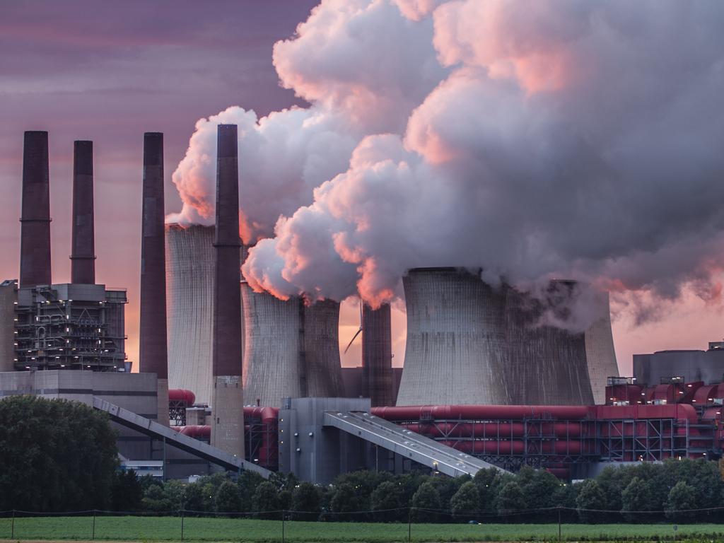 Steam rises off an industrial plant.