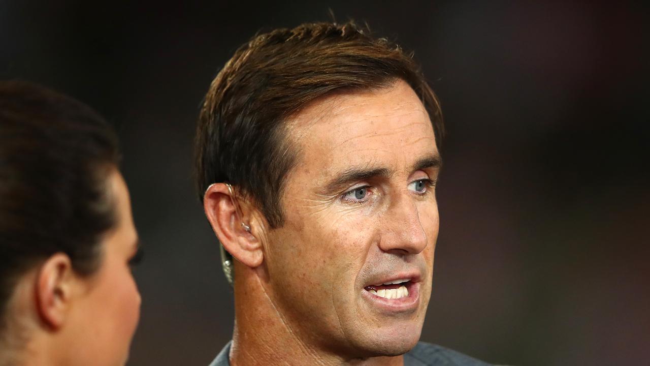 Andrew Johns looks on