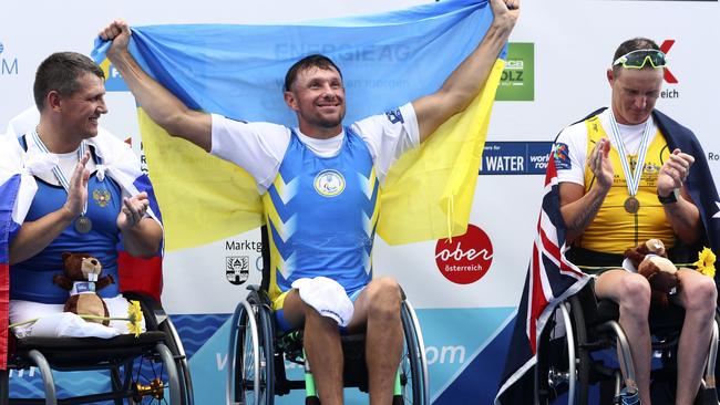 Silver medallist Alexey Chuvashev of Russia, gold medallist Roman Polianskyi of Ukraine and bronze medallist Erik Horrie of Australia on the podium after their race.