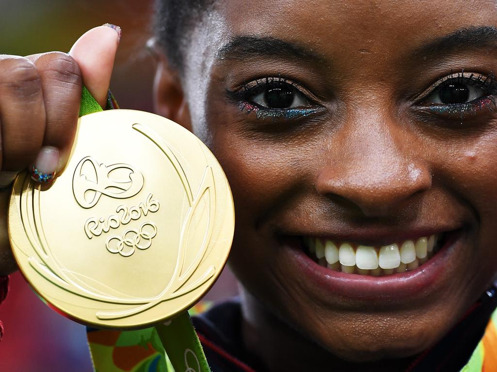 Simone Biles poses with her gold medal at the Rio 2016 Olympic Games.