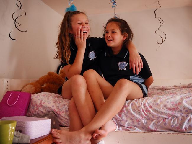 Sienna, 10, and Lily, 8, are happy to be back living with their parents. Picture: Sam Ruttyn