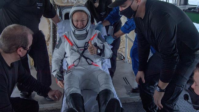 NASA astronaut Douglas Hurley is helped out of the SpaceX Dragon Endeavour spacecraft after landing in the Gulf of Mexico on Sunday. Picture: AFP