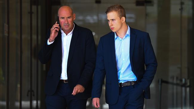 Mosman Swim Centre coach Kyle Daniels (right) leaves the Downing Centre Local Court in Sydney, Tuesday, February 18, 2020. (AAP Image/Paul Braven)