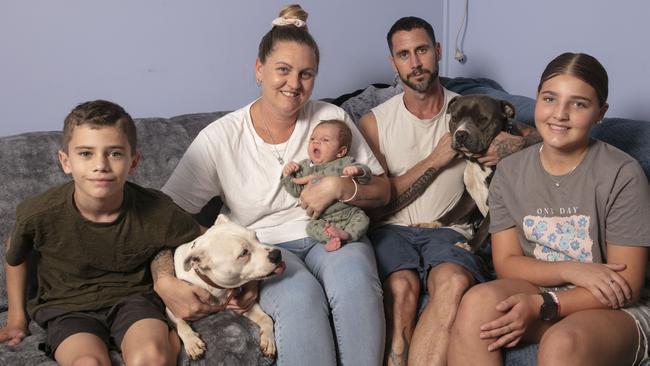 Jahnaya Mumford and her new baby Harlem with partner Cliff Clelland and her kids Kayden and Lillie-Lee and their pets, who were all rescued from their roof. Picture: Brendan Beirne