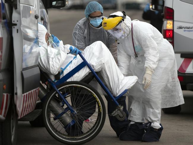 A passenger from the Australian cruise ship, the Greg Mortimer, is taken by military personnel to a hospital in Uruguay. Picture: Matilde Campodonico