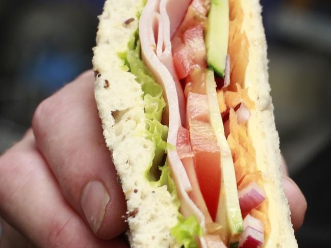 Leaf & Loaf owner Sacha Meikle with his  ham and salad sandwich, at his store in Orchid Plaza.